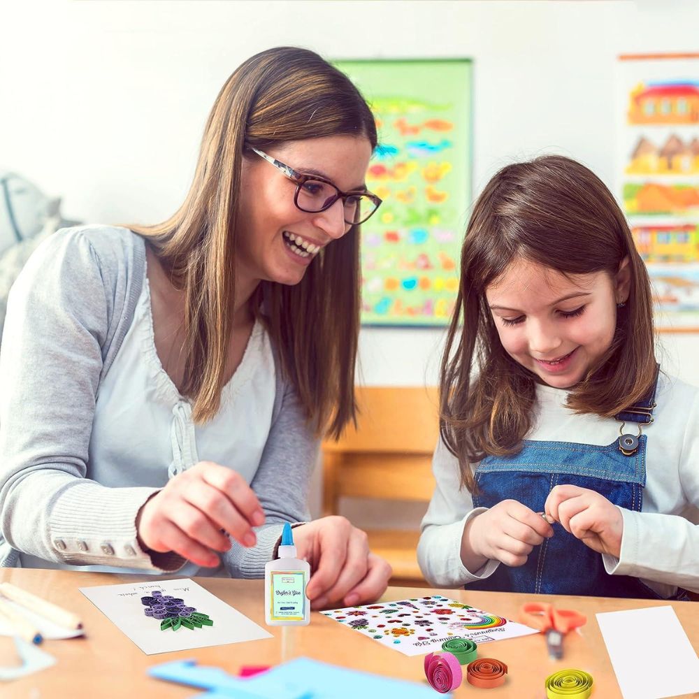 Teacher and student working on a craft project together in a classroom setting.